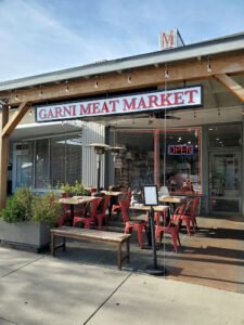 Petite neighborhood butcher shop offering some prepared foods